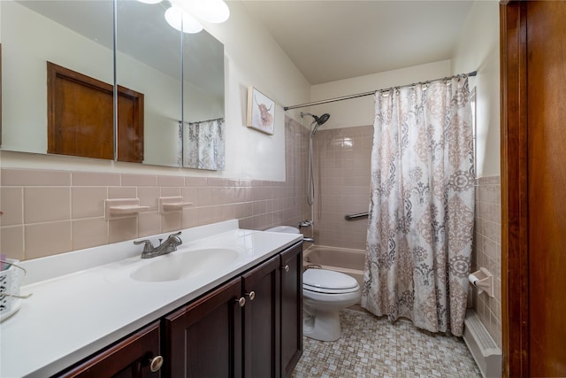 full bathroom featuring tile patterned floors, shower / bath combination with curtain, toilet, vanity, and tile walls