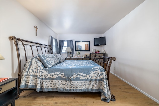 bedroom with hardwood / wood-style flooring