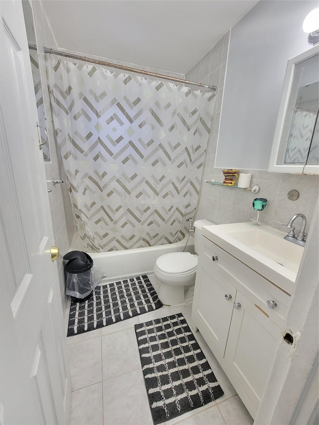 full bathroom with tile patterned flooring, vanity, toilet, and tile walls