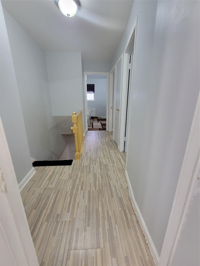 hallway with light hardwood / wood-style flooring