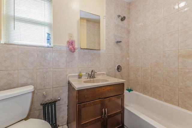 full bathroom featuring vanity, toilet, tile walls, and tiled shower / bath combo