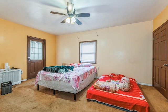 bedroom featuring multiple windows, light carpet, and ceiling fan