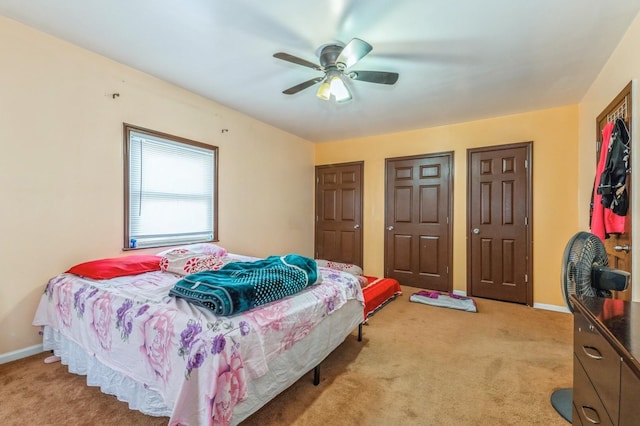 bedroom featuring ceiling fan and light carpet