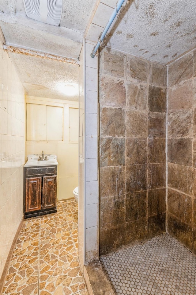 bathroom featuring walk in shower, vanity, and toilet