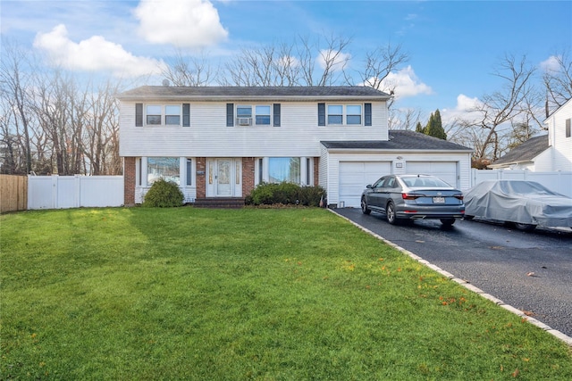 view of front of property featuring a garage and a front lawn