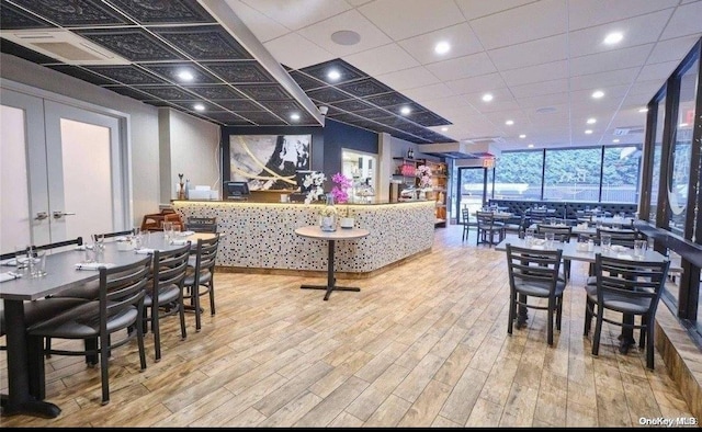 dining area featuring light hardwood / wood-style floors, floor to ceiling windows, and french doors