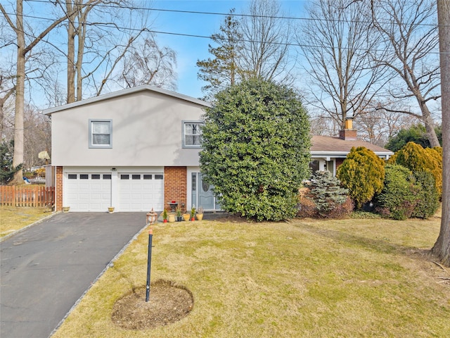 view of front of house with a garage and a front lawn