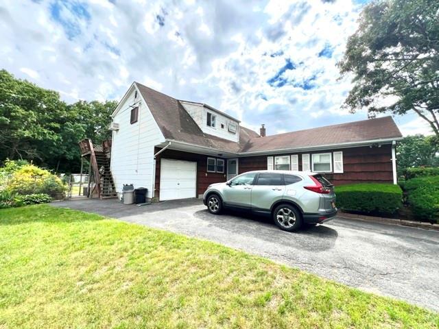 view of side of home with a yard and a garage