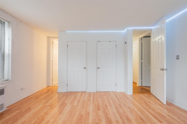 unfurnished bedroom with light wood-type flooring