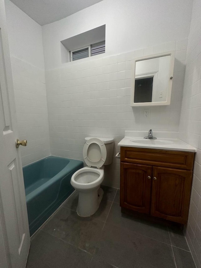 bathroom with tile patterned flooring, vanity, and toilet