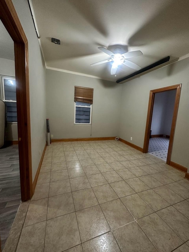 spare room featuring ceiling fan and crown molding