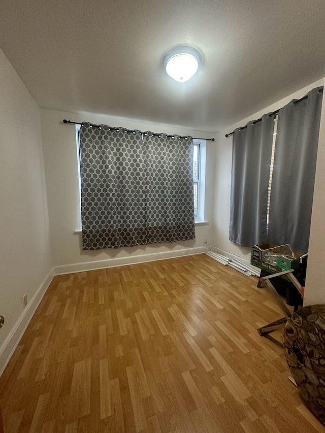 empty room with wood-type flooring