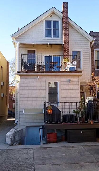 rear view of property featuring a balcony