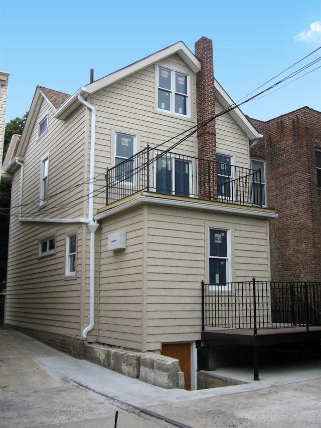 view of side of home with a balcony