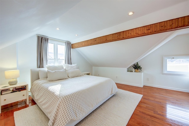 bedroom with vaulted ceiling and hardwood / wood-style flooring