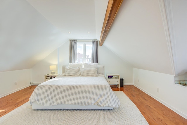 bedroom with lofted ceiling and wood-type flooring