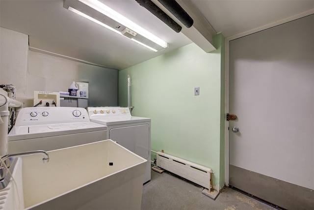 washroom featuring sink, a baseboard heating unit, and washing machine and clothes dryer