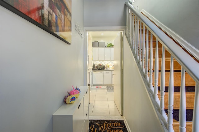 stairway with tile patterned floors