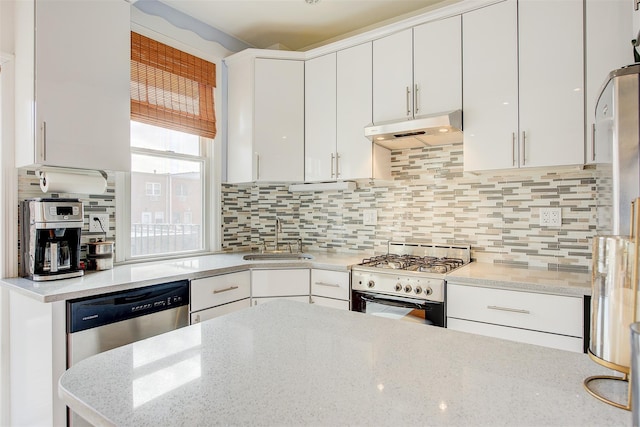 kitchen featuring sink, white gas range oven, dishwasher, white cabinetry, and backsplash