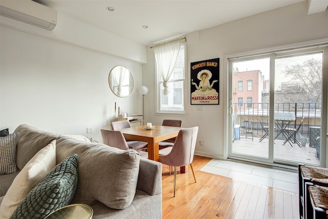 dining area with hardwood / wood-style flooring and a wall unit AC