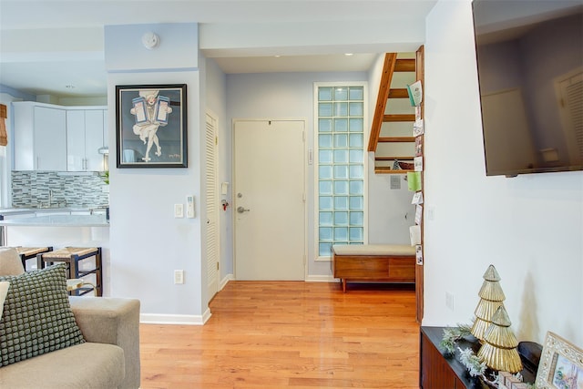 foyer with sink and light hardwood / wood-style flooring