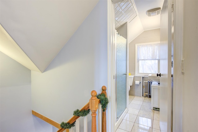 interior space with lofted ceiling and light tile patterned floors