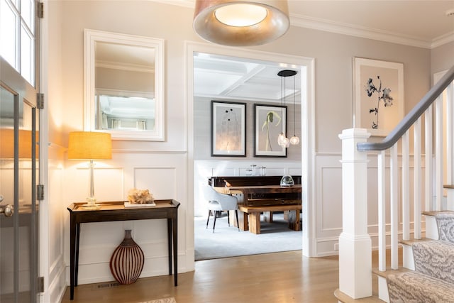 interior space featuring hardwood / wood-style flooring and ornamental molding