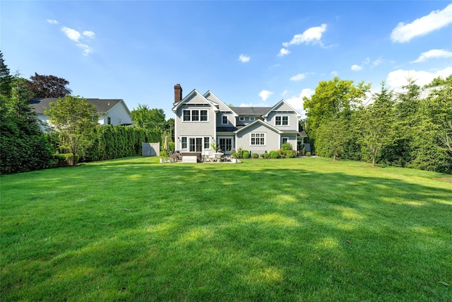 view of front of home with a patio area and a front lawn