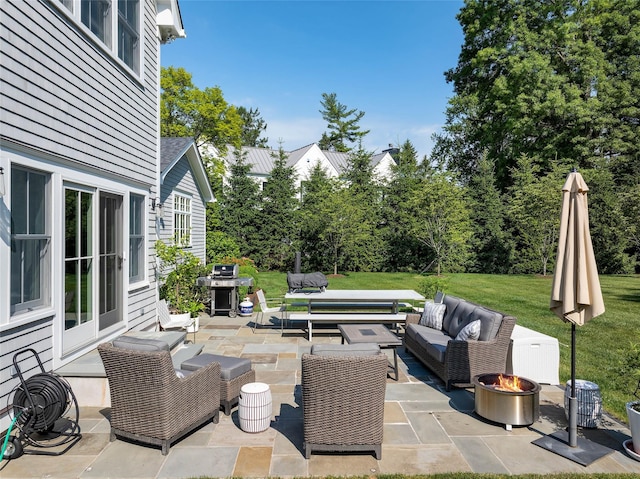 view of patio featuring area for grilling and an outdoor living space with a fire pit