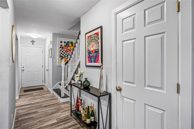 hallway with hardwood / wood-style floors