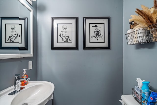 bathroom featuring sink and toilet