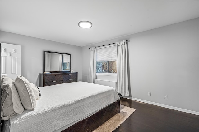 bedroom with dark hardwood / wood-style flooring