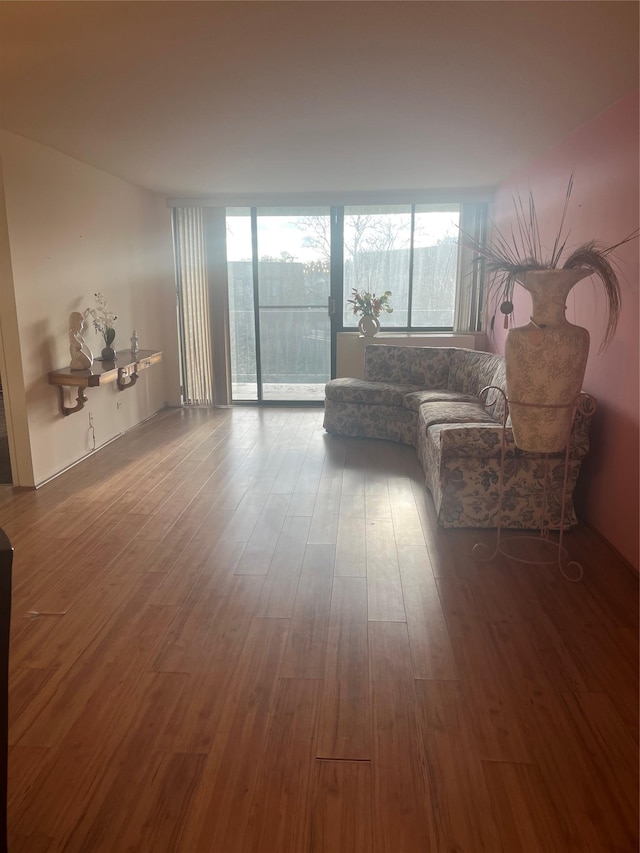 living room featuring hardwood / wood-style floors and a wall of windows