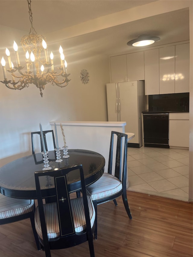 tiled dining area with an inviting chandelier