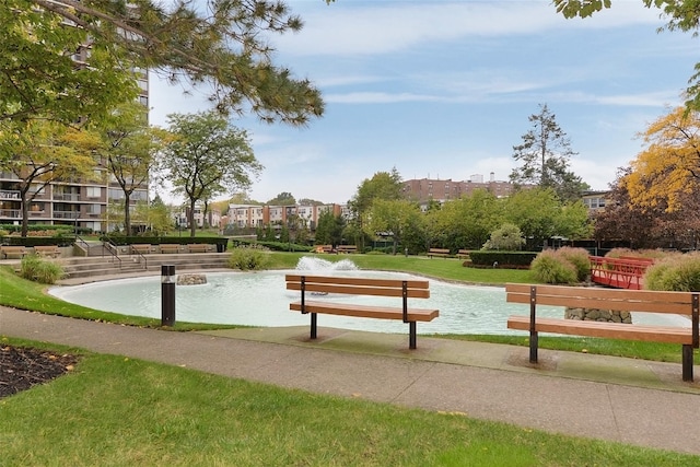 view of property's community with a yard and a water view