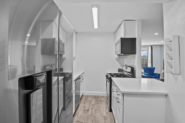 kitchen with white cabinets, stainless steel appliances, and light wood-type flooring