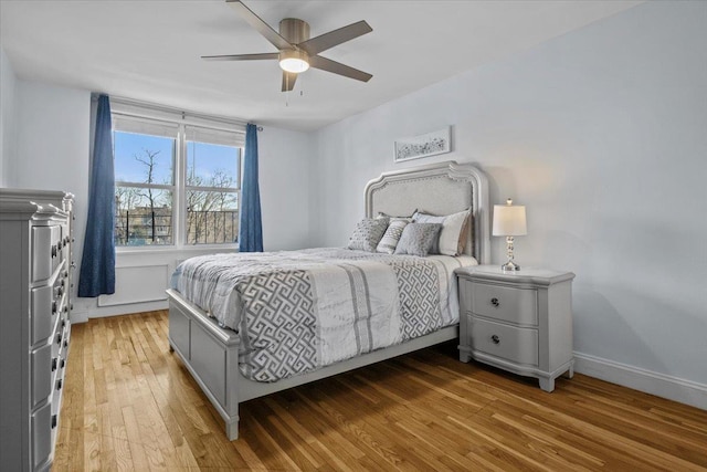 bedroom featuring hardwood / wood-style flooring and ceiling fan