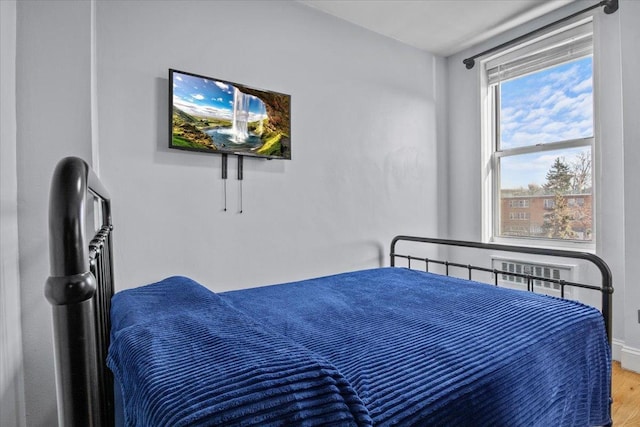 bedroom with hardwood / wood-style floors