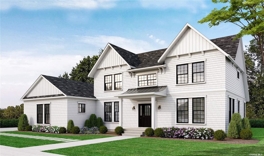 modern inspired farmhouse with a front lawn