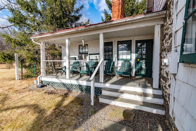 view of exterior entry with covered porch