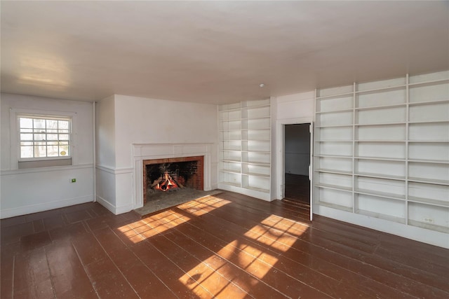 unfurnished living room with dark wood-type flooring