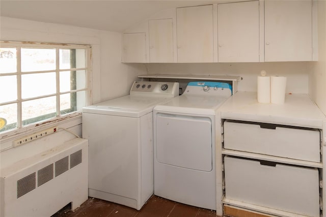 laundry room featuring separate washer and dryer, radiator heating unit, and cabinets