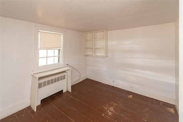 unfurnished room featuring radiator