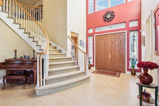 entryway featuring a towering ceiling