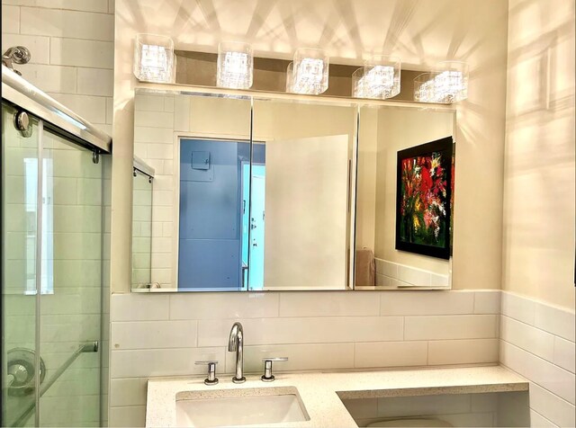 bathroom with backsplash, vanity, and walk in shower