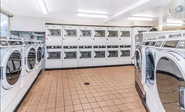 clothes washing area with washer and dryer and stacked washer and clothes dryer