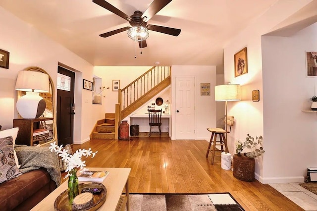 living room with light hardwood / wood-style floors and ceiling fan