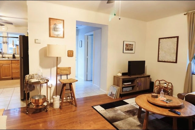 living room featuring ceiling fan and light wood-type flooring