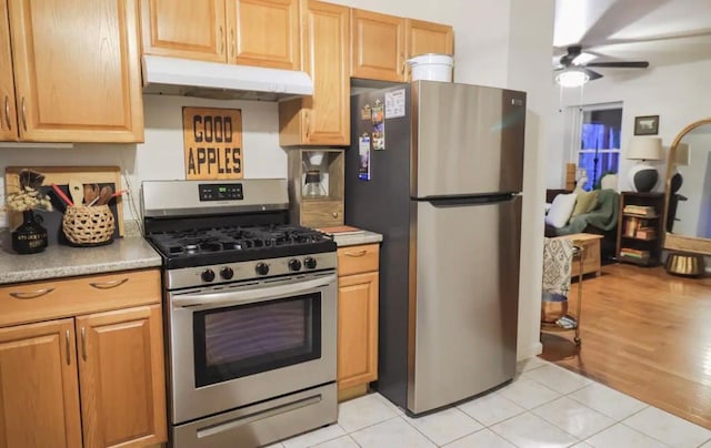 kitchen with light tile patterned floors, stainless steel appliances, and ceiling fan