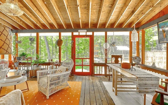 sunroom featuring beam ceiling, plenty of natural light, and wood ceiling